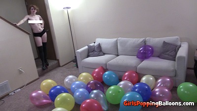 girl popping balloons